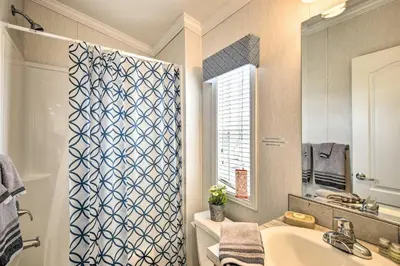 a bathroom with a sink and a shower curtain at Premium Cottages And Suites At Equestrian House in Pleasant Mount