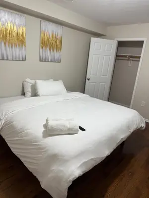 a white bed with a towel on top of it at Charming Large 3 beds-2 bath Newark EWR NYC in Newark