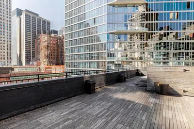 a balcony with a view of a city with tall buildings at Blueground Midtown East rooftop nr Bryant Park NYC-2070 in New York
