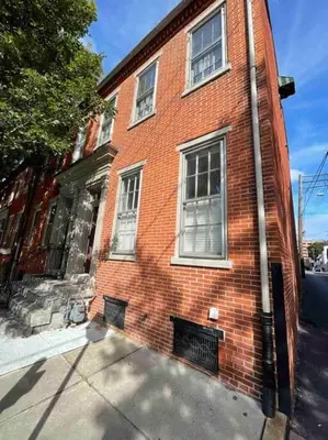 a red brick building with windows on a street at THE HANNAH HOUSE - DOWNTOWN HISTORIC LANCASTER in Lancaster