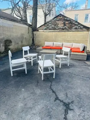 a group of white chairs and a table and a couch at 7 Large Bedrooms Art-Inspired Art House in Newark