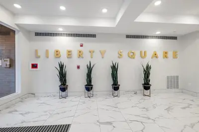 a lobby with a library square sign on the wall at Bright Studio Haven - Pool, Gym & Balcony Views in Philadelphia