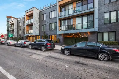 a row of cars parked on the side of a street at Bright 1BR Haven - Balcony Skyline Views in Philadelphia