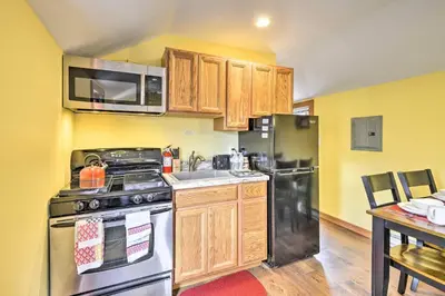 a kitchen with a stainless steel stove and refrigerator at Family Cabin and Suite Near Elk Mountain Ski Slopes in Pleasant Mount