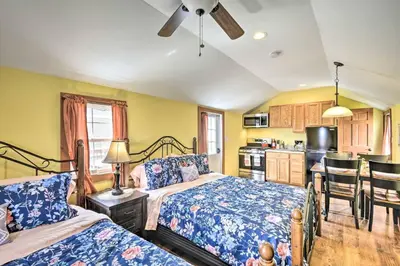 a bedroom with two beds and a kitchen at Family Cabin and Suite Near Elk Mountain Ski Slopes in Pleasant Mount