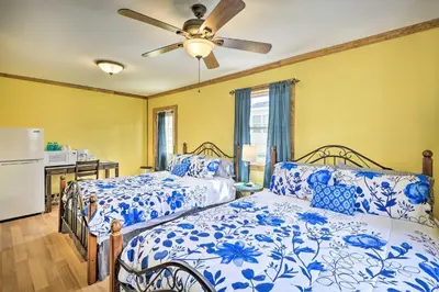 a bedroom with two beds and a ceiling fan at Wander & Unwind, Log Cabin and Suites Close to Ski Mountain in Pleasant Mount