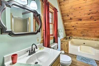 a bathroom with a sink and a toilet and a tub at Cozy Cabin and Suite Near Ski Resort in Pleasant Mount