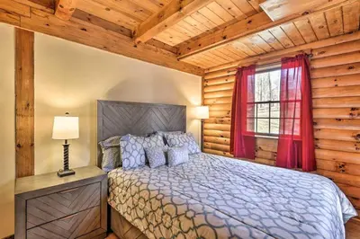 a bedroom with a bed and a window at Cozy Cabin and Suite Near Ski Resort in Pleasant Mount