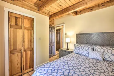 a bedroom with a bed and a wooden ceiling at Log Cabin and Cottage Near Elk Mountain Ski Slopes in Pleasant Mount