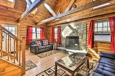 a living room with a fireplace in a log cabin at Log Cabin and Suite Close to Ski Adventures in Pleasant Mount