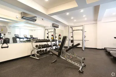 a room with a gym with treadmills and weights at Stylish Studio - Pool, Gym & Balcony Bliss in Philadelphia