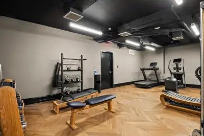 a room with a gym with benches and equipment at Freeman 901 by Rove Travel - Studio with Shared Amenities in New York