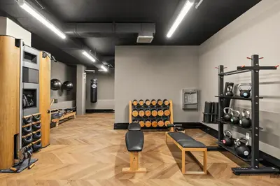 a room with a gym with dumbbells on the wall at Freeman 901 by Rove Travel - Studio with Shared Amenities in New York