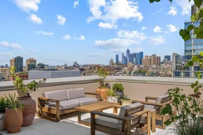a patio with a table and chairs on a roof at Freeman 1101 by Rove Travel - Studio with Shared Amenities in New York