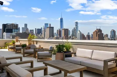 a rooftop patio with couches and a view of the city at Freeman 1201 by Rove Travel - Studio with Shared Amenities in New York