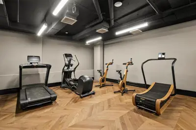 a gym with treadmills and exercise bikes in a room at Freeman 403 by Rove Travel - 1BR Condo with Shared Amenities in New York