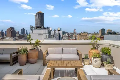a balcony with a couch and a view of a city at Freeman 403 by Rove Travel - 1BR Condo with Shared Amenities in New York