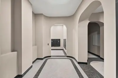 a hallway of a building with white walls and a carpet at Freeman 903 by Rove Travel - 1BR Condo with Shared Amenities in New York