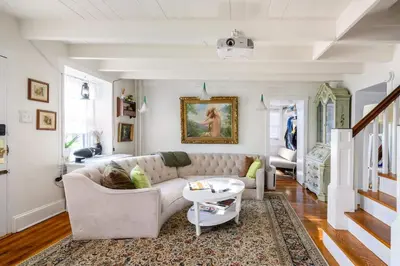 a living room with a couch and a table at Charming & Whimsical Historic River Home in Titusville