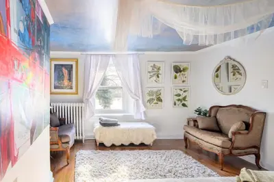 a living room with a couch and a window at Charming & Whimsical Historic River Home in Titusville
