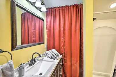 a bathroom with a sink and a red shower curtain at Cottage Complex Close to Ski Adventures in Pleasant Mount