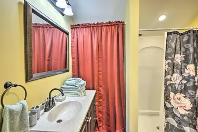 a bathroom with a sink and a red shower curtain at Gather, Celebrate, Unwind Close to Ski Trails in Pleasant Mount
