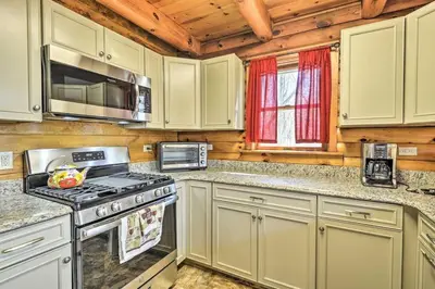 a kitchen with white cabinets and a stove top oven at Gather, Celebrate, Unwind Close to Ski Trails in Pleasant Mount