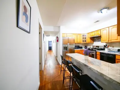 a kitchen with wooden cabinets and a counter top at Cozy Private Room with Shared Kitchen near NYC in Jersey City