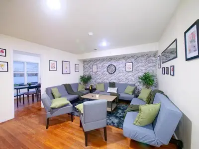 a living room with blue couches and a table at Mins to NYC Comfy Private Room in Shared Home in Jersey City