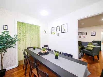 a living room with a table and chairs and a couch at Mins to NYC Comfy Private Room in Shared Home in Jersey City