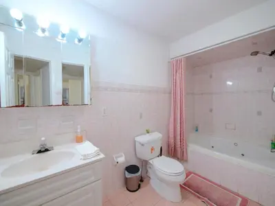 a bathroom with a sink and a toilet and a tub at Charming Room with Shared Space close to NYC in Jersey City