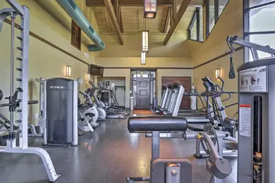 a gym with several treadmills and cardio machines at Game Room, Hot Tub and Fire Pit Pocono Lake Escape! in Pocono Lake