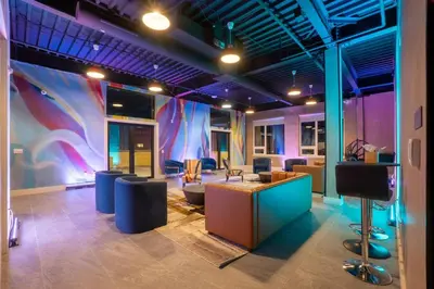 a room with a lobby with chairs and a stage at Smoked Amber Stay, Free Parking, Sleep 5, 20 percent OFF in East Orange