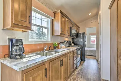 a kitchen with a sink and a refrigerator at Suite to Unwind Close to Skiing in Pleasant Mount