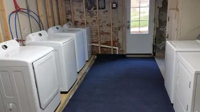 a laundry room with four washing machines in it at Crossroads at Park Place in Wilmington