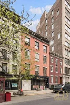 a large brick building on a city street at Classic NYC Brownstone 2Br Apartment in Prime Chelsea in New York