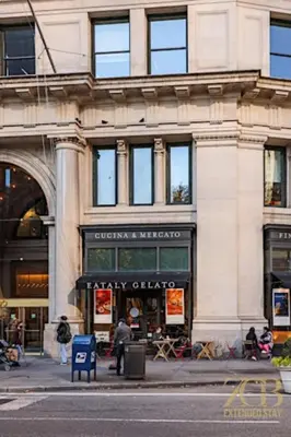 a building on a city street with a store at Classic NYC Brownstone 2Br Apartment in Prime Chelsea in New York