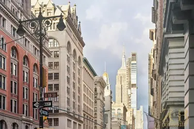 a city street with tall buildings and street signs at Modern 2BR Terrace WD & Elevator in NoMad in New York