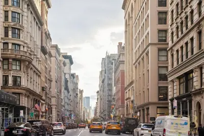 a busy city street filled with cars and buildings at Spacious 3BR Flex 4 with Washer & Dryer in NoMad in New York