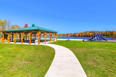 a park with a gazebo and a playground at Waterfront Arrowhead Lake Retreat with Resort Perks! in Pocono Lake