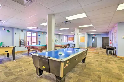 a large room with pool tables and ping pong tables at Waterfront Arrowhead Lake Retreat with Resort Perks! in Pocono Lake