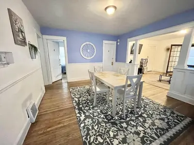 a dining room with a table and chairs on a rug at Affordable for Crews Binghamton Close to Job Sites in Binghamton