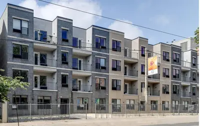 an apartment building with a fence in front of it at Bright 1BR unit in the Fairmount Square building in Philadelphia