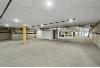 an empty parking garage with cars parked in it at Attractive 1BR1BA apartment at Fairmount Square in Philadelphia