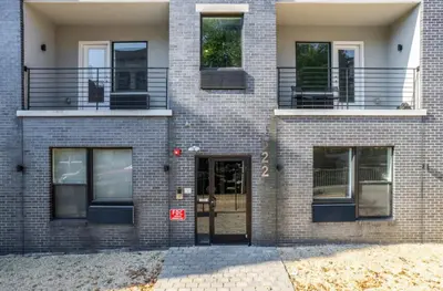 a brick building with a door and a balcony at Comfortable updated 1BR in Fairmount Square in Philadelphia