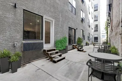 a patio with a table and benches and a building at Comfortable updated 1BR in Fairmount Square in Philadelphia