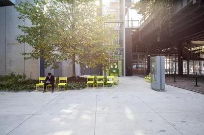 a person sitting on a chair under a tree in a building at Central Chelsea 1BR w Gym Doorman NYC-20 in New York
