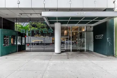 a glass entrance to a building with a pole at Blueground Midtown South rooftop nr Bryant Park NYC-2031 in New York