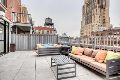 a patio with couches and a table on a building at Chelsea 1BR w Water views Doorman NYC-210 in New York