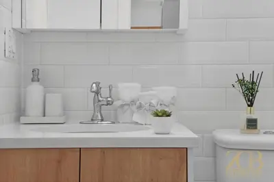 a white kitchen with a sink and a toilet at 517 - 47C Beautifully Renovated 1 bedroom in Prime Manhattan in New York